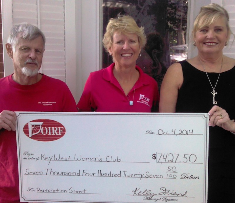 Roberta Spencer, President of the Key West Woman's Club, receives a check from John Johnson and Kelly Friend of the OIRF.  Funds were needed to improve storm protection for the Hellings House, home of the KWWC since 1940.