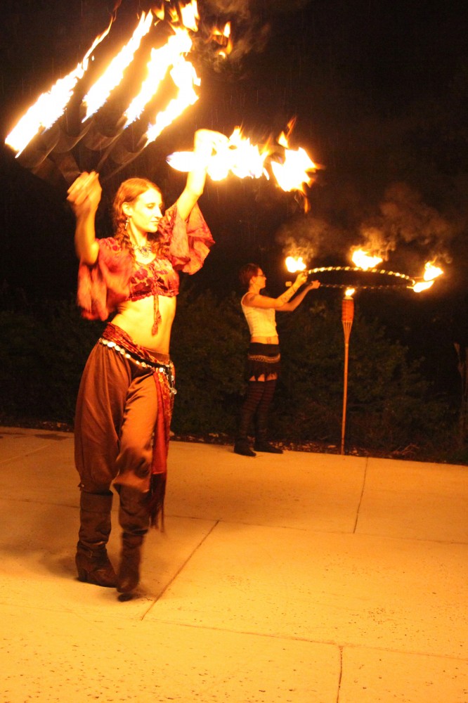 Michele Meck and Lydia Firefly dance with fire at a previous Midsummer’s Night Dream & Spectacle.